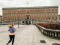 Woman jogging in front of the Stockholm Royal Palace, Sweden