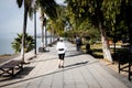 Woman jogging in the morning on the boardwalk malecÃÂ³n of Lake Chapala