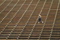 Woman jogging across bleacher seating Red Rocks Amphitheater in Morrison Colorado