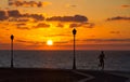 A woman jogging at sunrise on the coast, Caleta de Fuste, Fuerteventura, Canary Islands, Spain