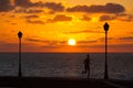 A woman jogging at sunrise on the coast, Caleta de Fuste, Fuerteventura, Canary Islands, Spain
