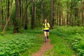 woman jogging on a trail in a natural forest park Royalty Free Stock Photo