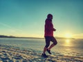 Woman jogging on winter beach run. Female athlete runner Royalty Free Stock Photo