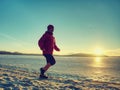 Woman jogging on winter beach run. Female athlete runner Royalty Free Stock Photo