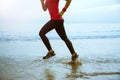 Woman jogging workout on the beach in the morning. Relax with the sea walk. Jump up and fun on workout Royalty Free Stock Photo