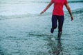 Woman jogging workout on the beach in the morning. Relax with the sea walk. in summer Royalty Free Stock Photo