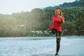 Woman jogging workout on the beach in the morning. Relax with the sea walk. in summer Royalty Free Stock Photo