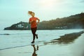 Woman jogging workout on the beach in the morning. Relax with the sea walk Royalty Free Stock Photo