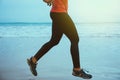 Woman jogging workout on the beach in the morning. Relax with the sea walk Royalty Free Stock Photo