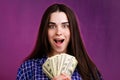 Woman joyfully holding in her hand lot of dollars Royalty Free Stock Photo