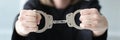 The woman judge in a black dress holds handcuffs, close-up Royalty Free Stock Photo