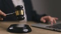 Woman judge hand holding gavel to bang on sounding block in the court room Royalty Free Stock Photo