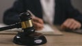 Woman judge hand holding gavel to bang on sounding block in the court room Royalty Free Stock Photo