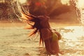 Woman jump hair water splash at sunset Royalty Free Stock Photo