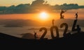 Woman jump happy new year 2024 concept, silhouette of woman jumping over barrier cliff and success with beautiful sunset Royalty Free Stock Photo