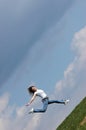 Woman jump over a grass field Royalty Free Stock Photo