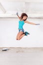 Woman jump and paints the wall with white paint Royalty Free Stock Photo