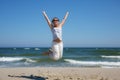 Woman in a jump shot on the beach of the Baltic sea Royalty Free Stock Photo