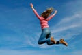 Woman Jumping in the Air With Arms Outstretched Royalty Free Stock Photo