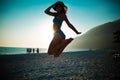 Woman jumping in the air on tropical beach,having fun and celebrating summer,beutiful playful woman in white dress jumping of hap Royalty Free Stock Photo