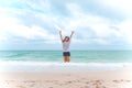 A woman jumping on the beach in front of the sea with feeling happy Royalty Free Stock Photo