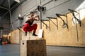 Woman jumping on a box in a cross training gym Royalty Free Stock Photo