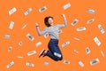 Woman jumping with clenched fist, celebrating winning lottery, money rain, dollars falling. Royalty Free Stock Photo