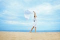 Woman jumping with cloth on a beach Royalty Free Stock Photo