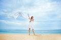 Woman jumping with cloth on a beach Royalty Free Stock Photo