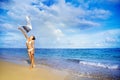 Woman jumping with cloth on a beach Royalty Free Stock Photo