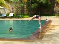 woman jumping dives in hotel pool - Siem Reap, Cambodia 02/21/2011. Royalty Free Stock Photo