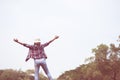 Woman jumping enjoying relax on green grass and flower field in Royalty Free Stock Photo