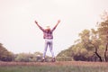 Woman jumping enjoying relax on green grass and flower field in Royalty Free Stock Photo