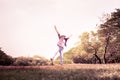 Woman jumping enjoying relax on green grass and flower field in Royalty Free Stock Photo