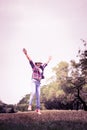 Woman jumping enjoying relax on green grass and flower field in Royalty Free Stock Photo