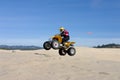 Woman jumping her ATV in the dunes Royalty Free Stock Photo