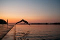 Woman jumping into the lake from wooden pier. Having fun on summer day. Young girl diving in to the water from the dock. Royalty Free Stock Photo