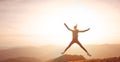 Woman jumping on mountain on sunset sky and mountains background Royalty Free Stock Photo