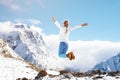 Woman jumping on mountain in winter