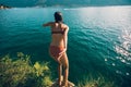 Woman jumping off cliff into the sea. Royalty Free Stock Photo