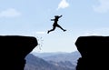 Woman jumping over abyss. Royalty Free Stock Photo