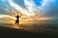 Woman jumping on sand at the sea in sunset. freedom life concept Royalty Free Stock Photo