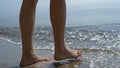 Woman jumping sea waves on sunlight close up. Girl legs splashing ocean water. Royalty Free Stock Photo