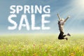 Woman jumping with text of spring sale