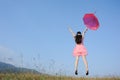 Woman jumping to blue sky with red umbrella Royalty Free Stock Photo