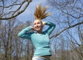 Woman jumps in the early spring wood Royalty Free Stock Photo
