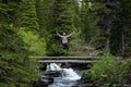 Woman Jumps For Joy On Wooden Bridge