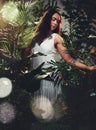 Woman, jungle and flower hair in leaves, trees and rainforest for beauty, fashion and cosmetics. Girl, nature model and