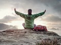 Woman just enjoying the life. Beautiful girl backpacker sit on top