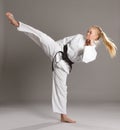 Woman karate actively working legs.